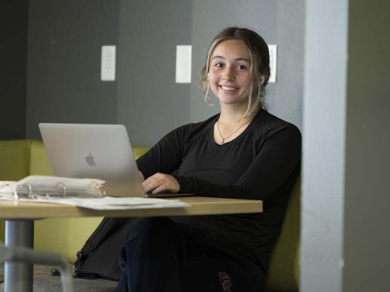 female student working on a laptop