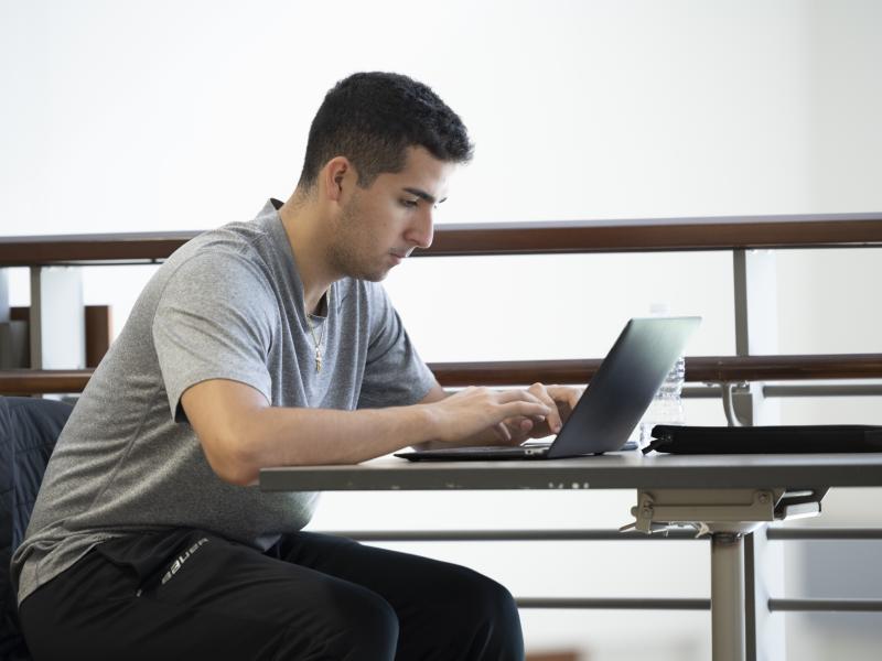 male student on laptop