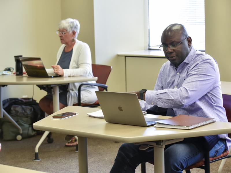 two nontraditional students in a classroom at the syracuse campus