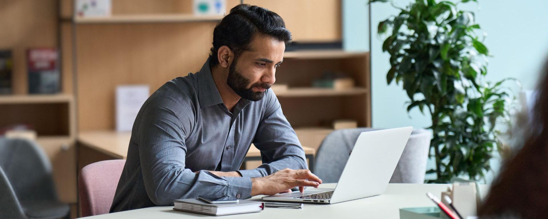 male student studying on a laptop