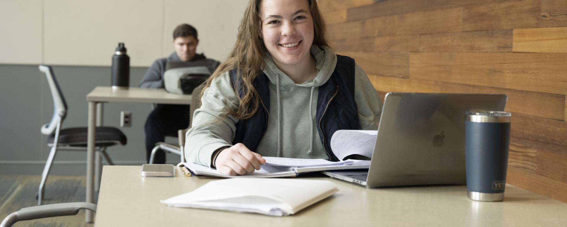 female student working on a laptop