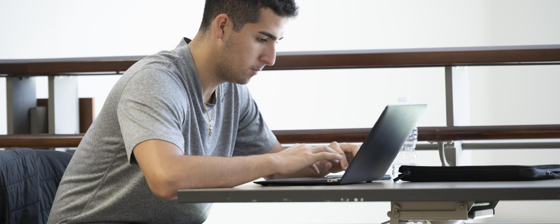 male student on laptop