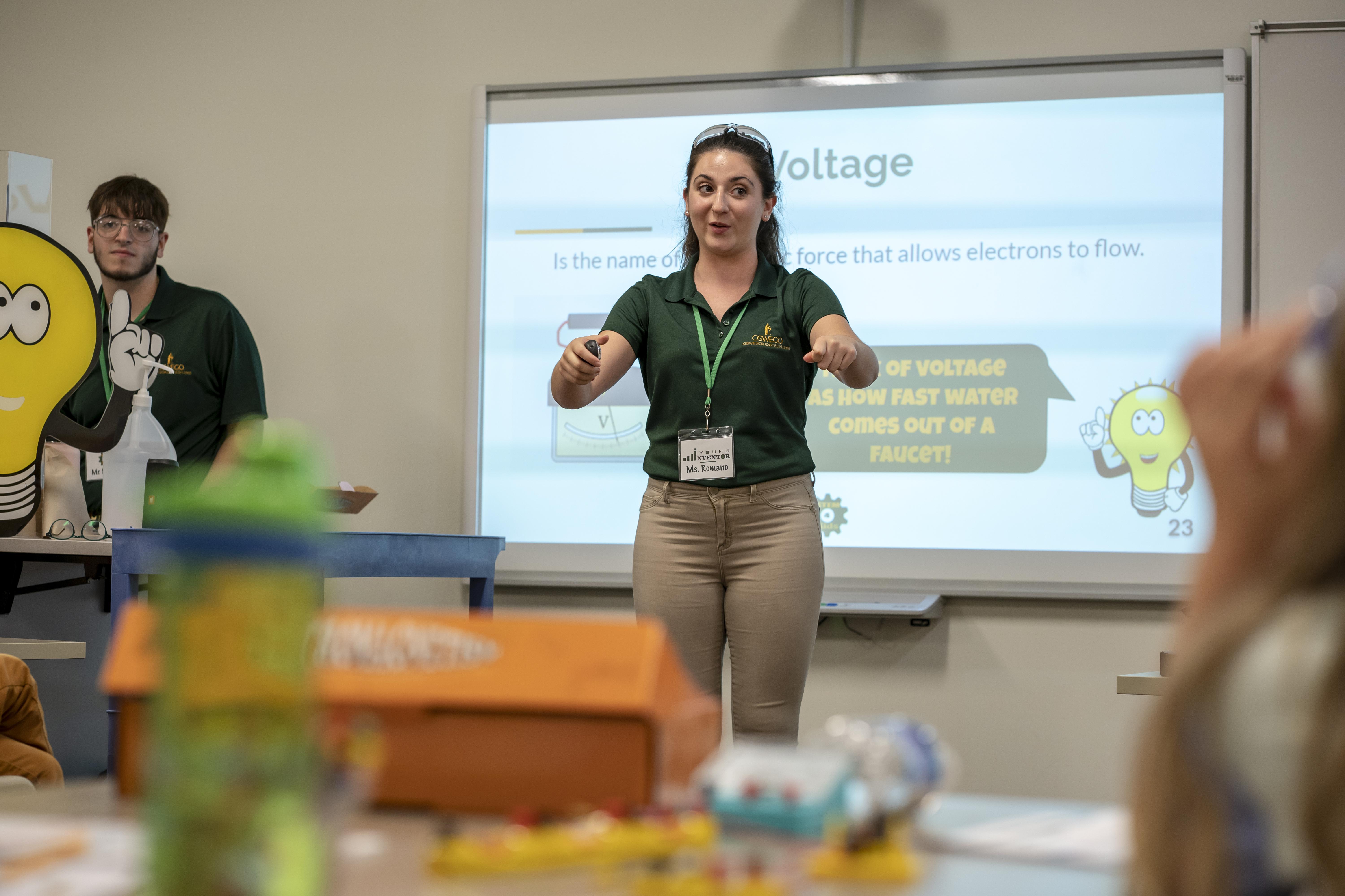 female student giving a presentation in front of a class