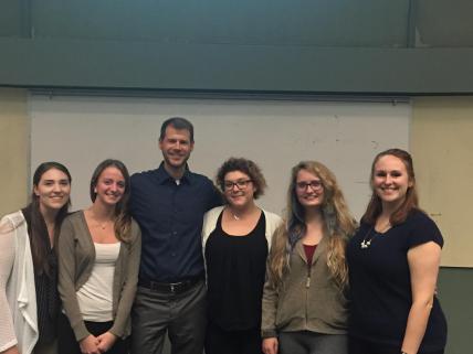 Social psychologist, Jon Maner, poses for photo with students