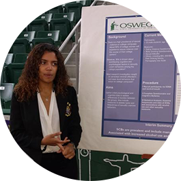 Psychology student presenting research poster at Quest