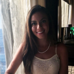 Alumni Demi Siskand sitting at table
