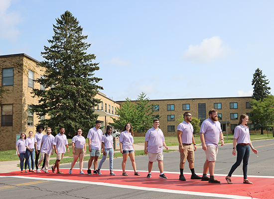 Mackin Complex (Moreland and Lonis Halls) and Sheldon Hall Resident Student Staff group photo. Re-enact the album cover of Abbey Road for fun.