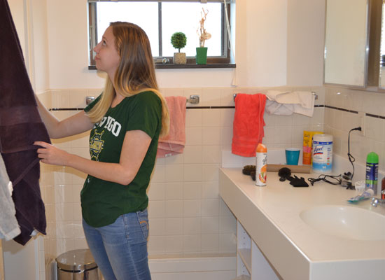 student gets her towel in her spacious village townhouse bathroom
