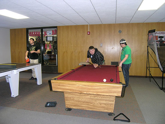 Students enjoy playing pool, ping-pong and basketball in the spacious Cayuga Hall main lounge.