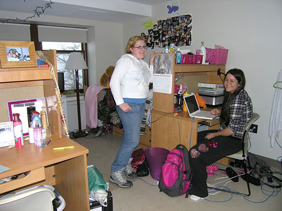 Female student working at her desk in a Johnson Hall bedroom.