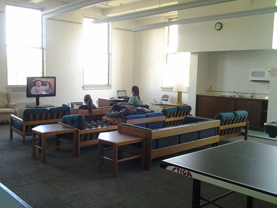 Students relax and watch television in the spacious and airy Sheldon Hall main lounge.