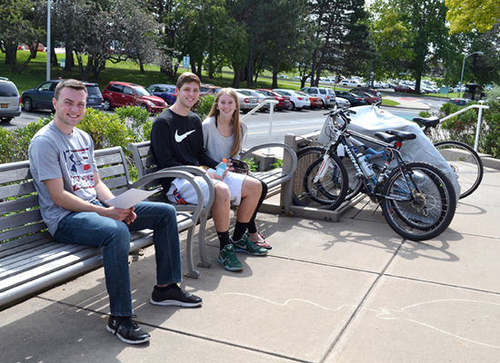 Riggs Hall patio entrance littered with residents' bikes on a sunny day.