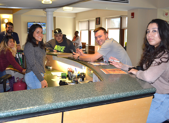 Students welcome you to Riggs Hall front desk.