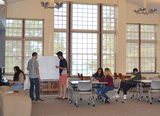 Riggs Hall main lounge; where students can lounge, study, play piano, or gaze out at Lake Ontario through floor to ceiling windows.
