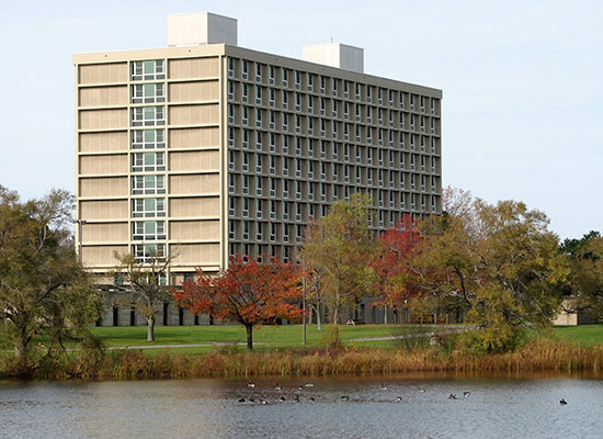 Seneca Hall on a beautiful fall day; with water fowl on Glimmerglass Lagoon.