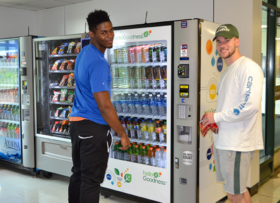 Seneca Hall residents grab a snack from the vending machine in the lobby.