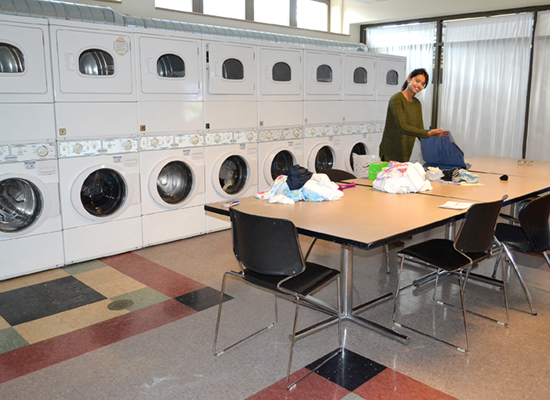 A Hart Hall resident has this spacious laundry room all to herself while folding a big pile of clothes.