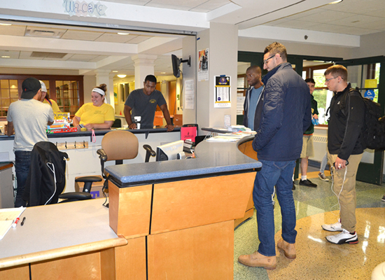 Johnson Hall front desk is a busy place for staff and students.