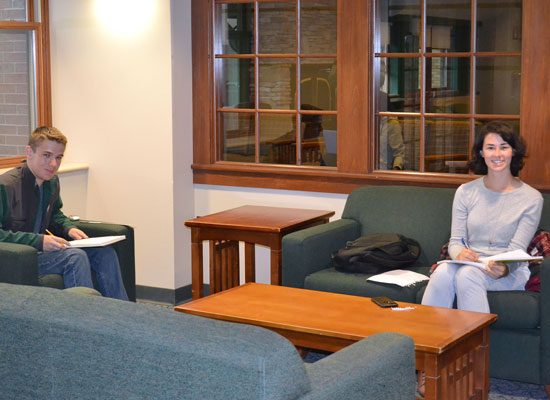Students do homework in a public seating area just outside of the Johnson Hall main lounge.