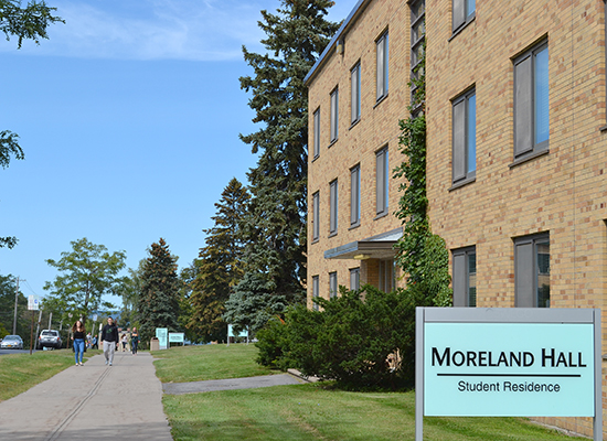 Moreland Hall (part of the Mackin Complex) sign on the side lawn of the building.