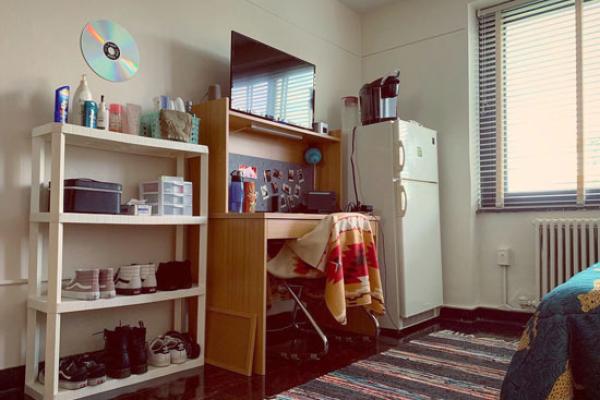 Lonis Hall (part of the Mackin Complex) room includes desk with a lighted hutch and fridge.