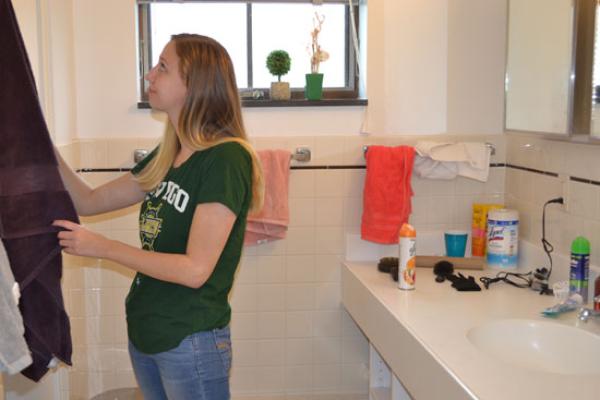 student gets her towel in her spacious village townhouse bathroom