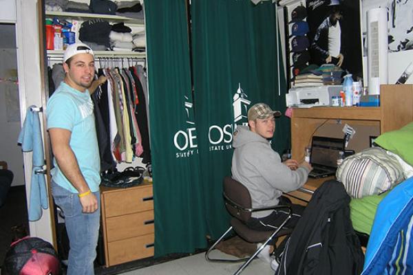 2 male students in an Onondaga Hall room.