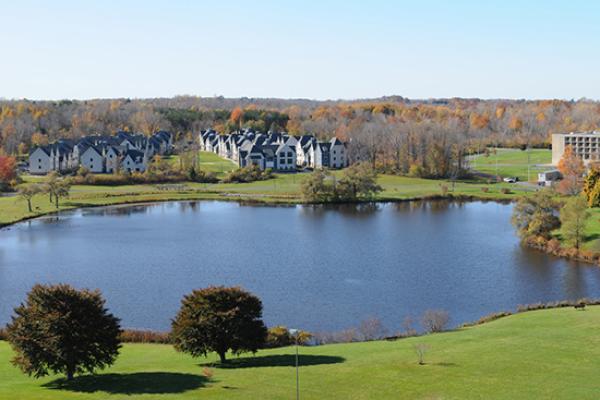Fall scene of The Village nestled on Glimmerglass Lagoon.