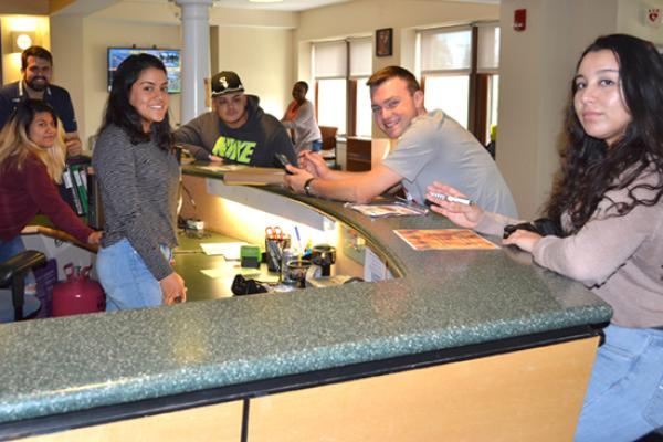Students welcome you to Riggs Hall front desk.