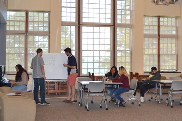 Riggs Hall main lounge; where students can lounge, study, play piano, or gaze out at Lake Ontario through floor to ceiling windows.