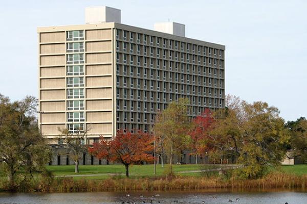 Seneca Hall on a beautiful fall day; with water fowl on Glimmerglass Lagoon.
