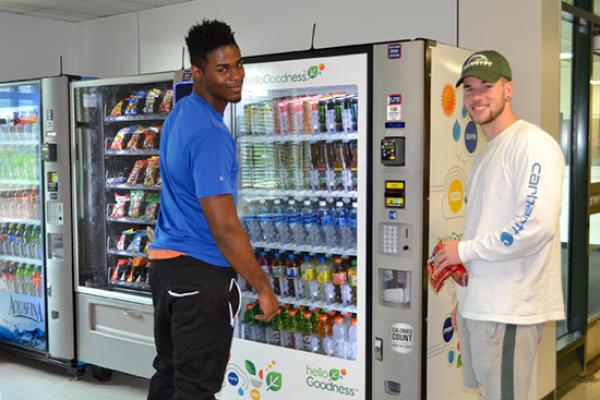 Seneca Hall residents grab a snack from the vending machine in the lobby.