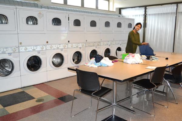 A Hart Hall resident has this spacious laundry room all to herself while folding a big pile of clothes.