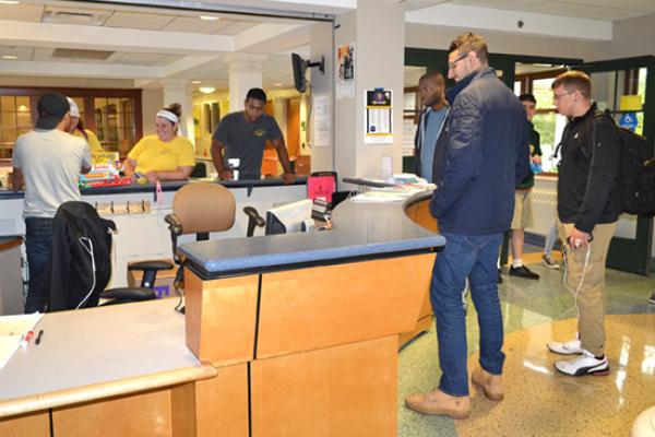 Johnson Hall front desk is a busy place for staff and students.