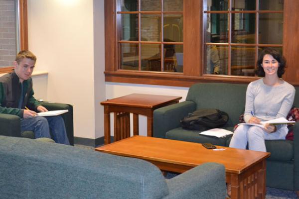 Students do homework in a public seating area just outside of the Johnson Hall main lounge.