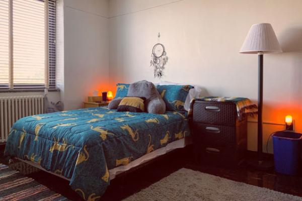 Lonis Hall (part of the Mackin Complex) resident in her single room with a fridge, full size bed, and double closets.