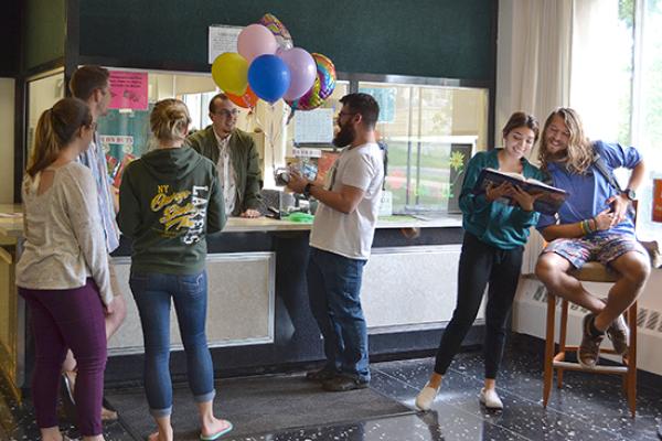 Funnelle Hall front desk with students.