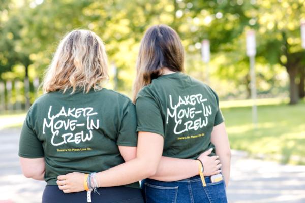 Two Laker Move-In Crew members wearing "Laker Move-In Crew" T-shirts, facing away from camera
