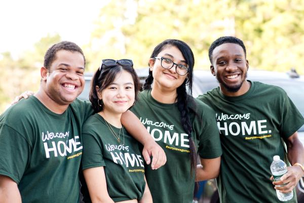 Four Laker Move-In Crew Members together, smiling at the camera