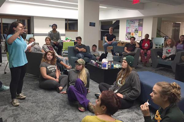Students attend a presentation in the Scales Hall basement lounge.