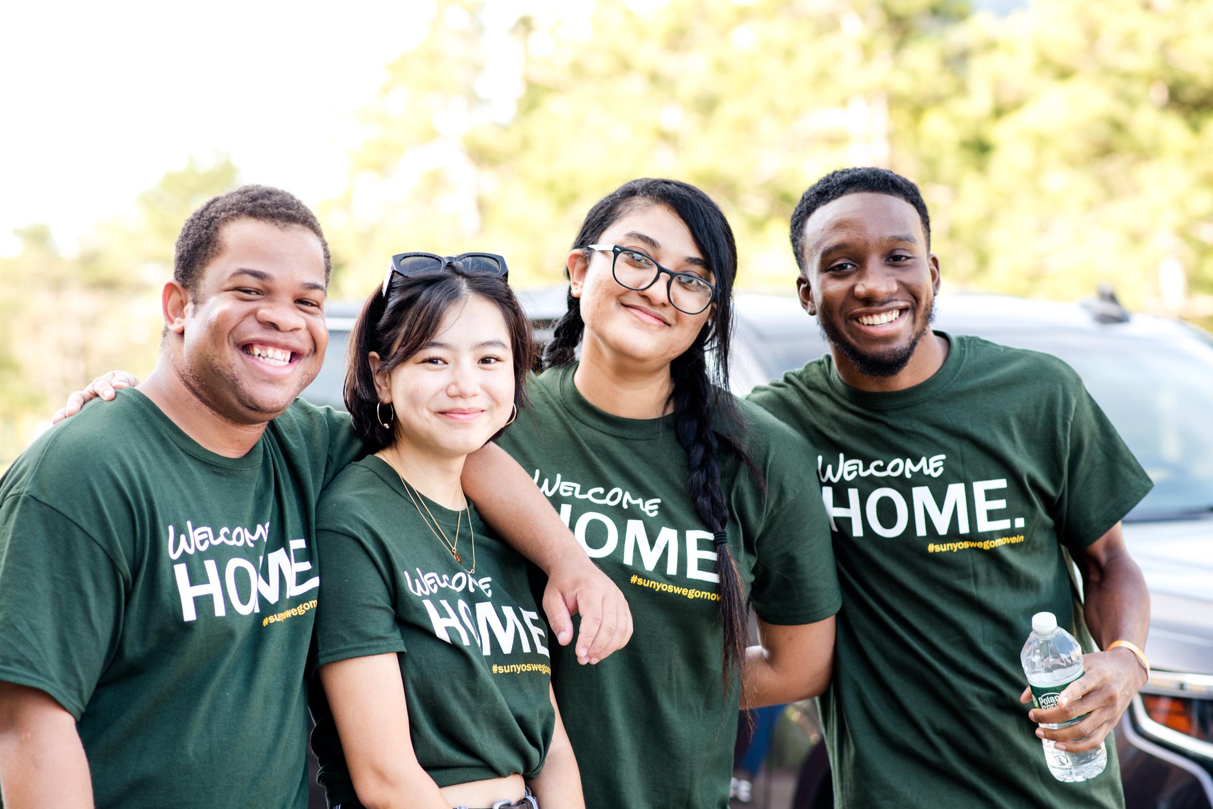 Four Laker Move-In Crew Members together, smiling at the camera