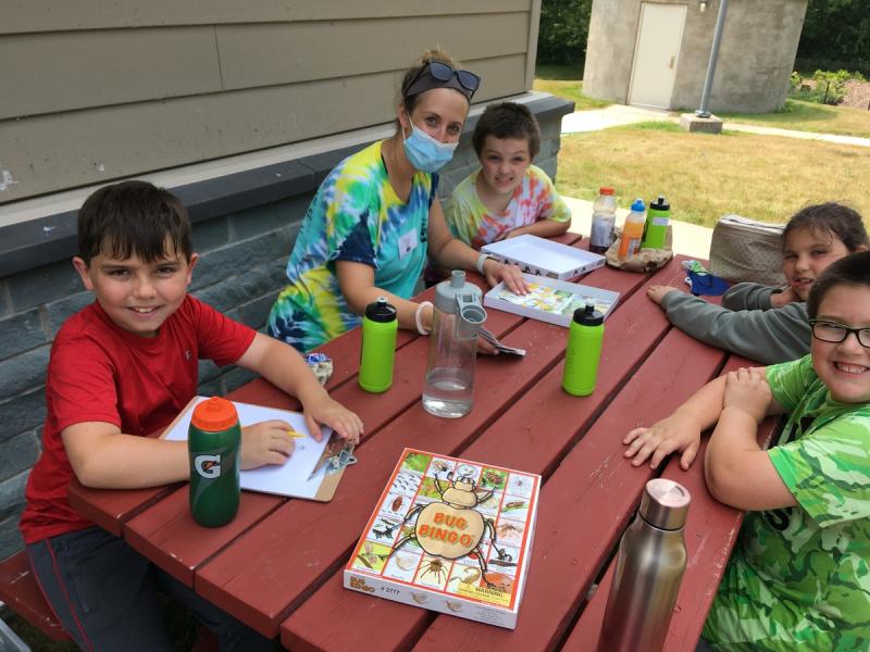 children and instructor at a picnic table