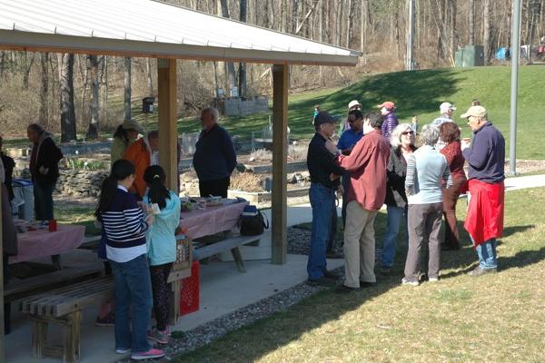 Earth Day celebration by the pavilion and herb garden People gathered by the pavilion