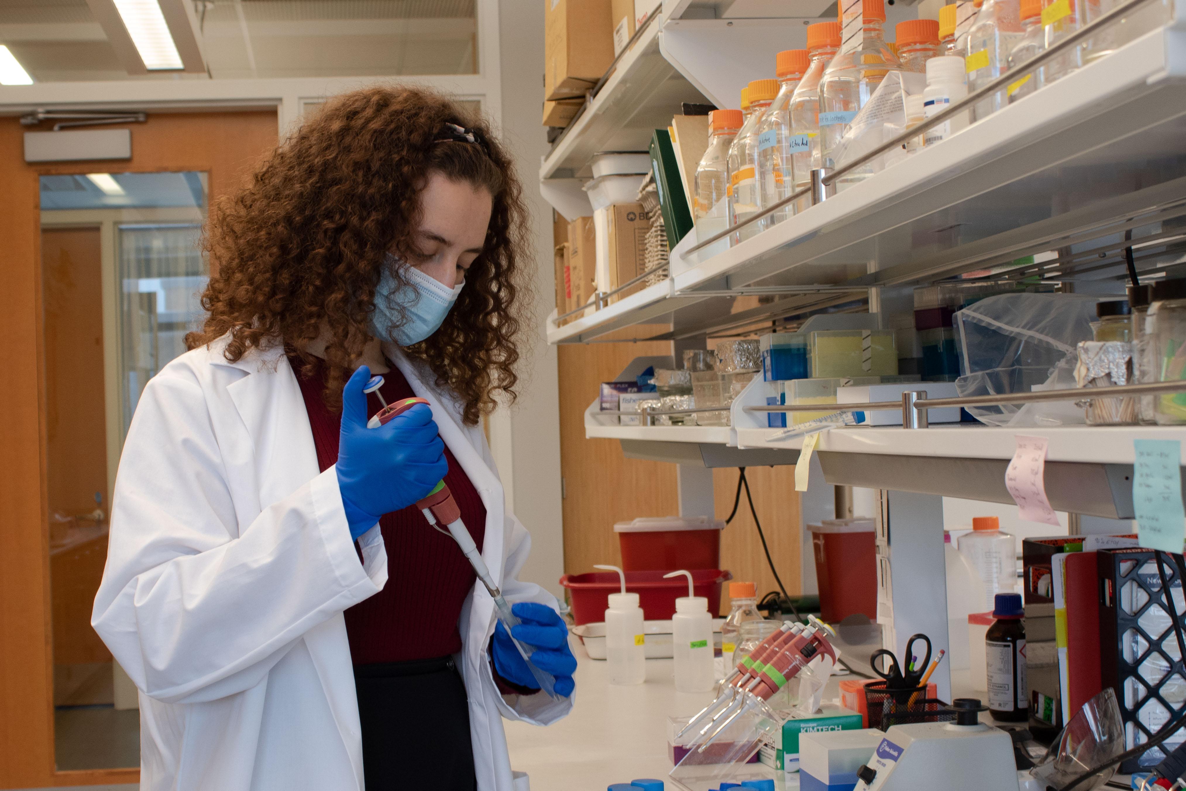 Miryam pipetting in the laboratory