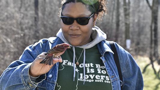 Woman holding a bird in hand