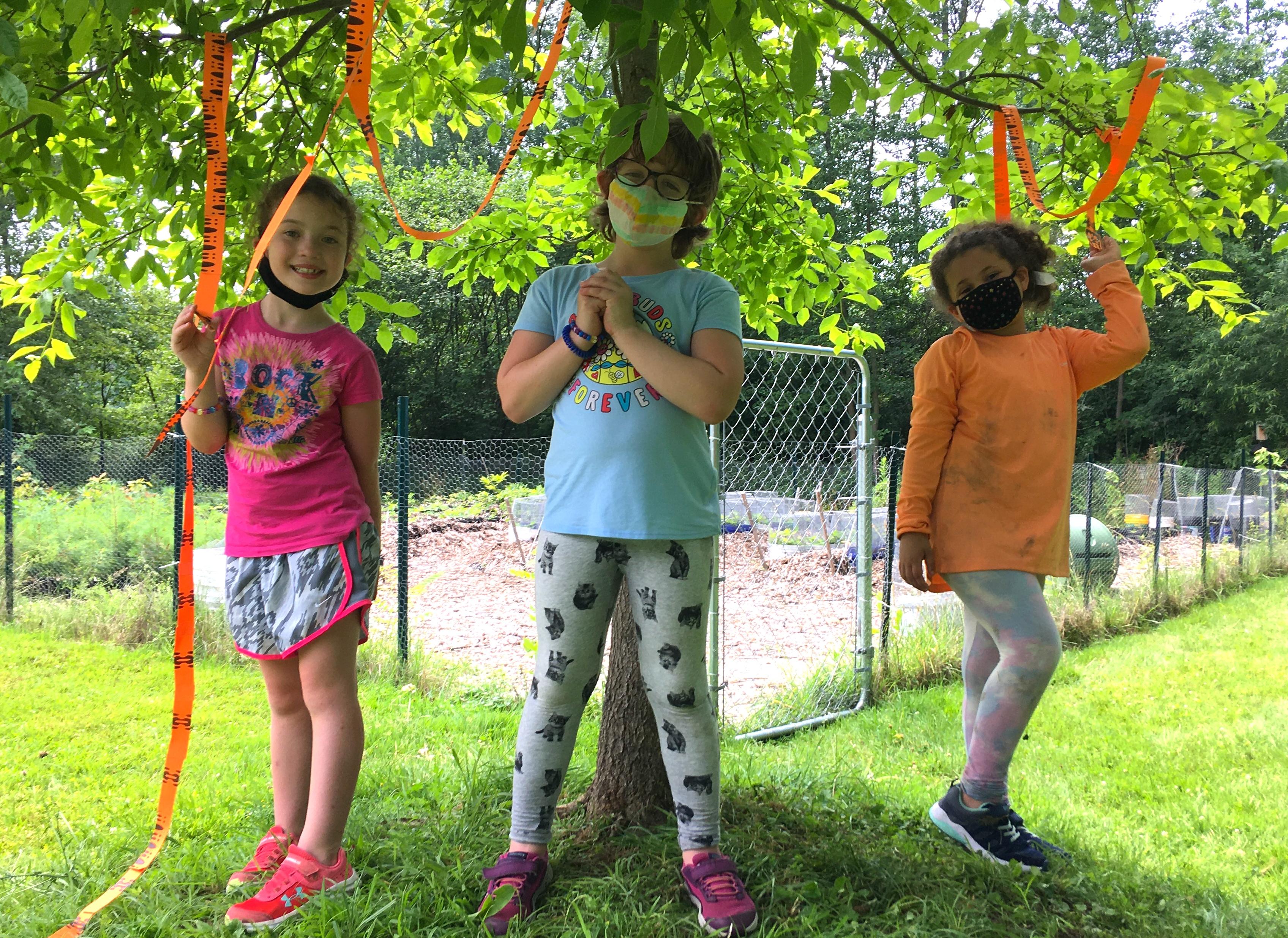 three girls under a tree