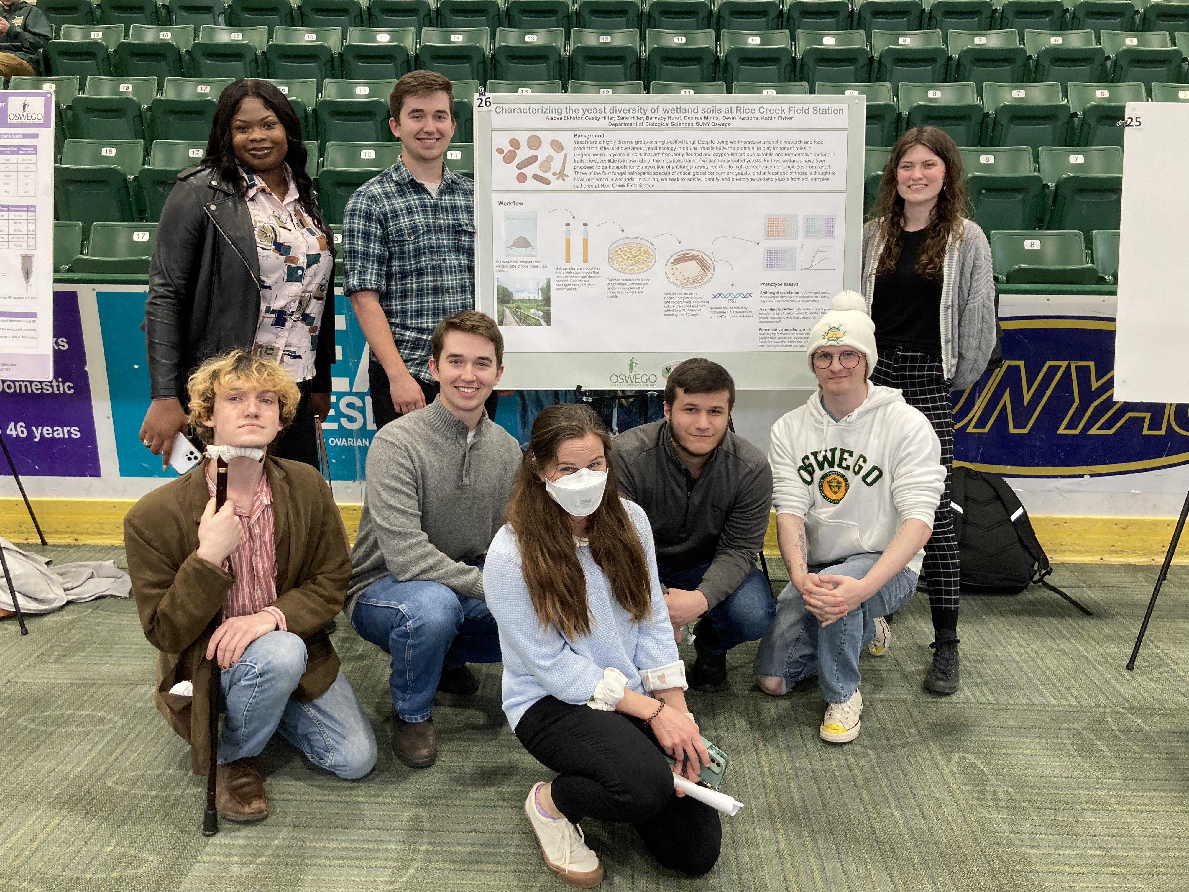 Eight individuals standing by a scientific poster