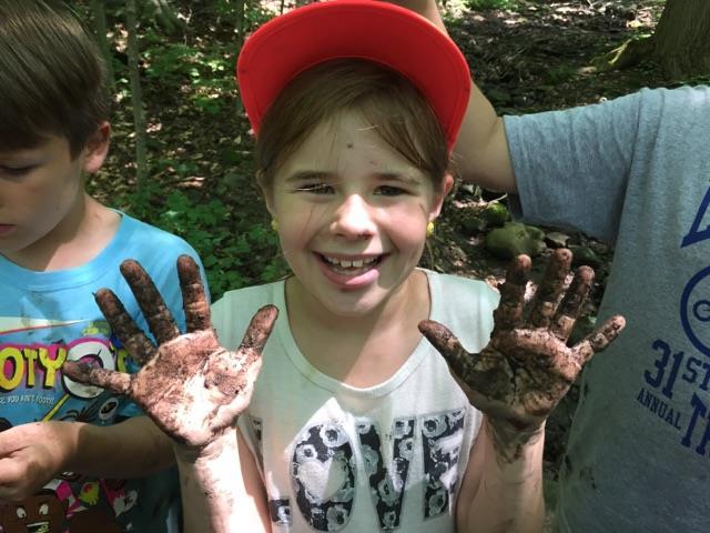 Child with muddy hands