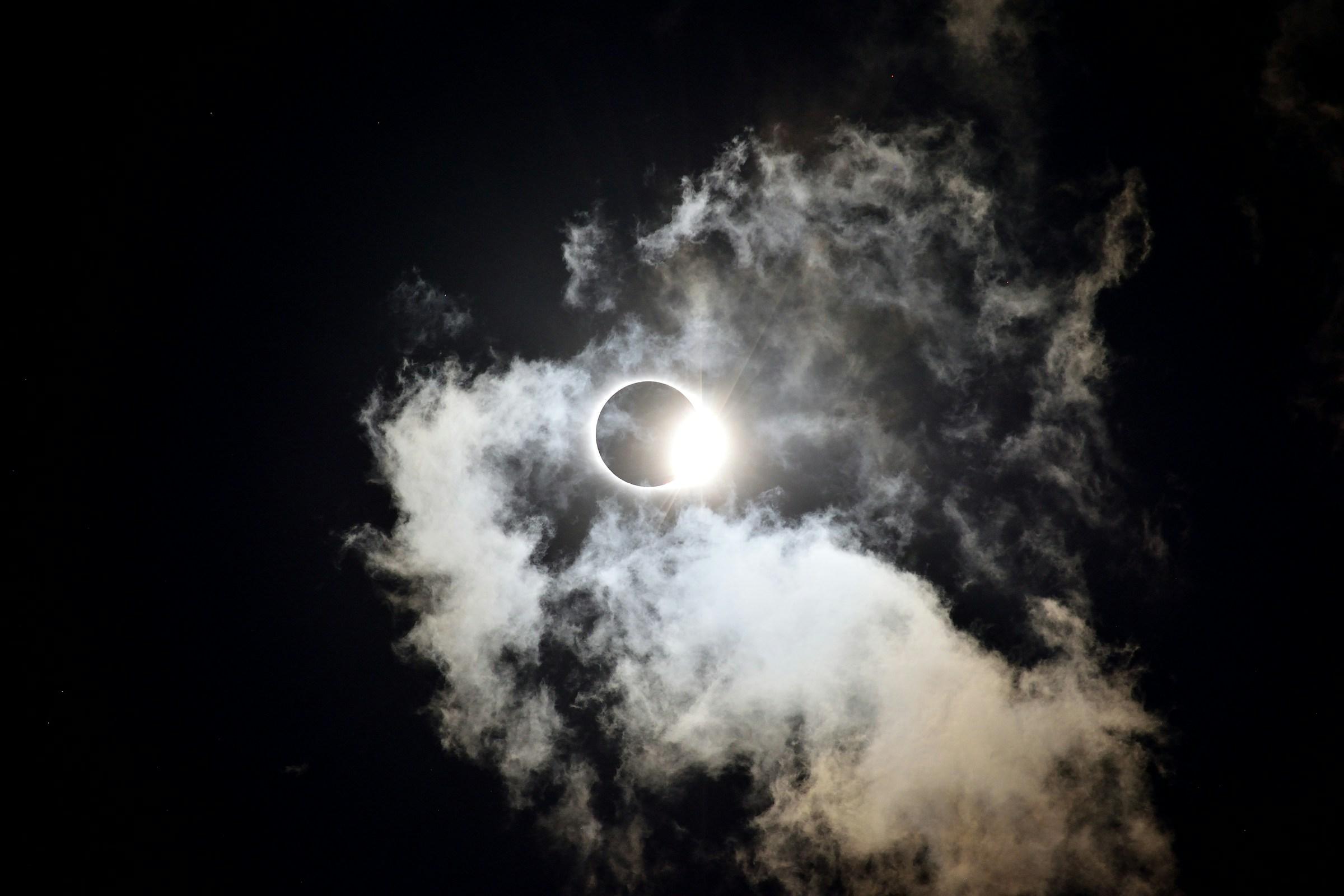 Image of a solar eclipse with clouds