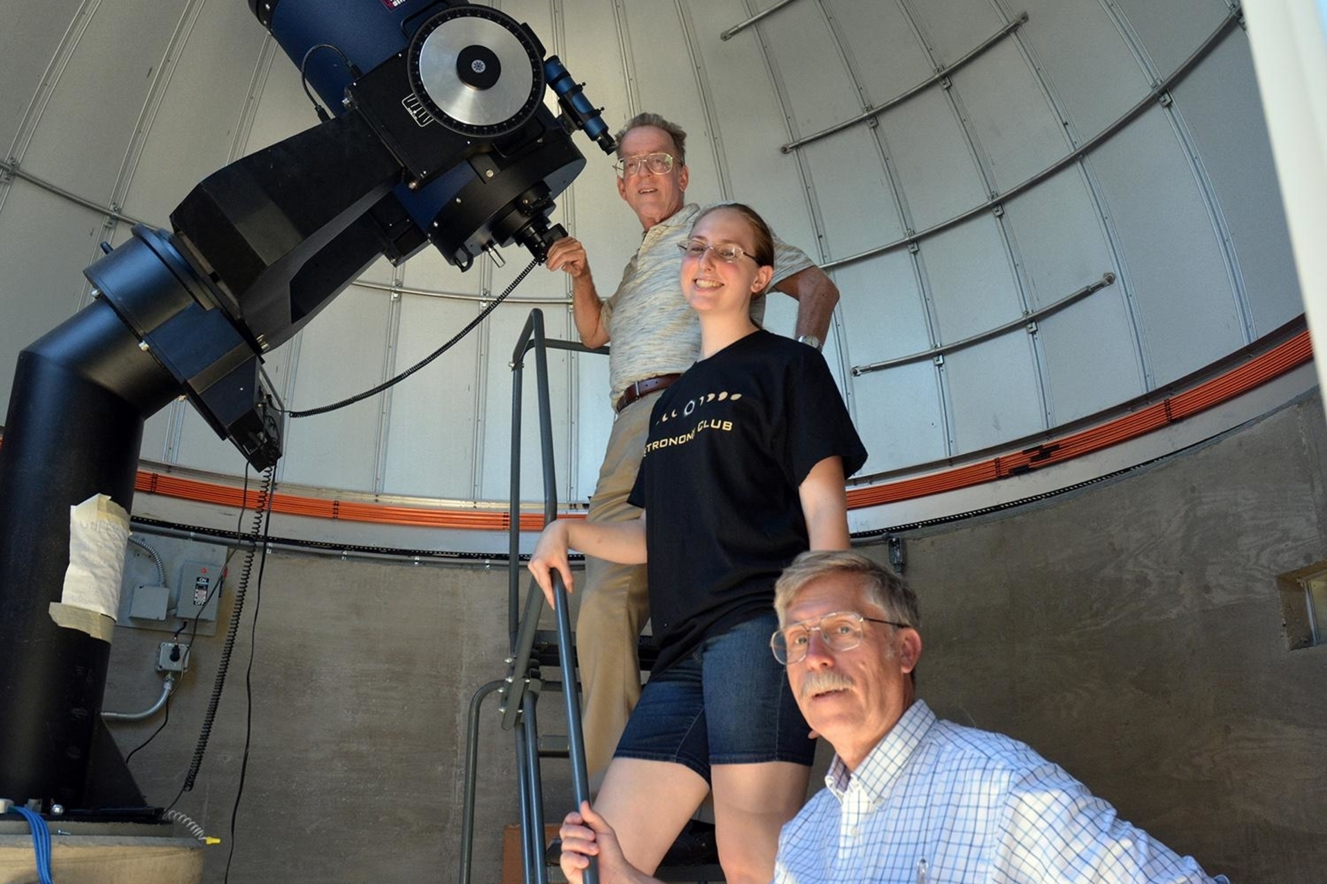 three people inside observatory